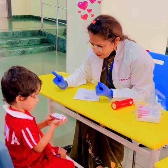 Dr. Alka Khade examining a young child during a dental checkup, demonstrating her gentle approach to kids dentistry