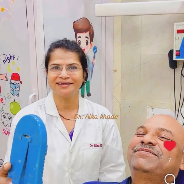 Dr. Alka Khade smiling with a patient at her dental clinic in Juinagar, Navi Mumbai